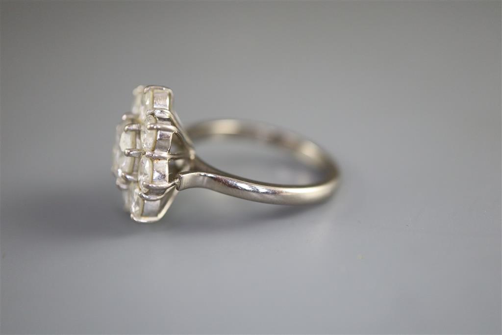 A 1970s 18ct white gold and nine stone diamond cluster ring,